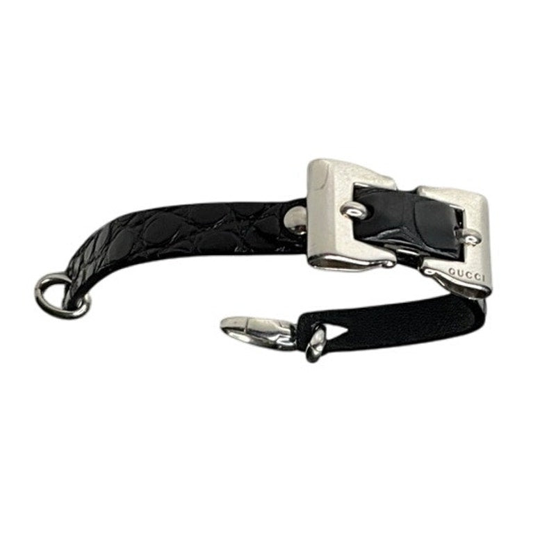 Black leather bracelet with silver buckle on a white background