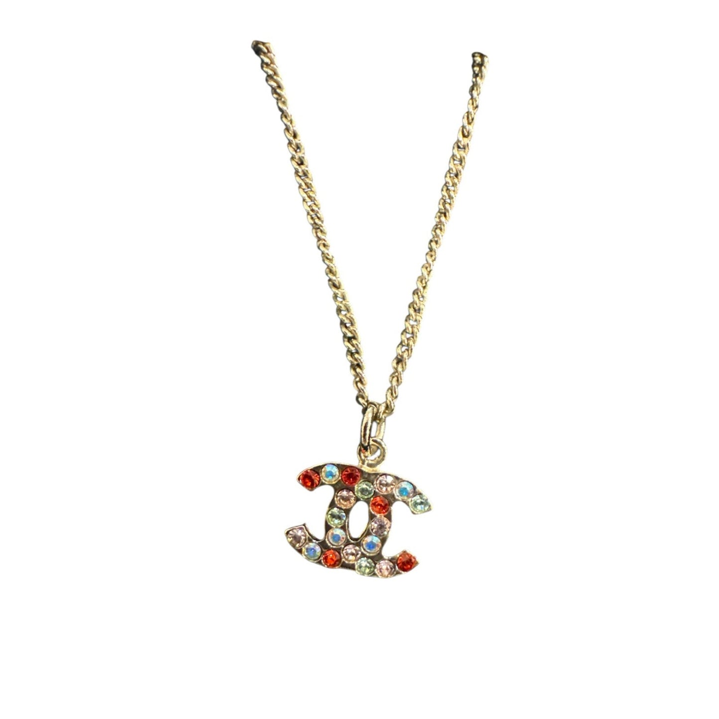 Gold necklace with a colorful 'CC' pendant on a white background