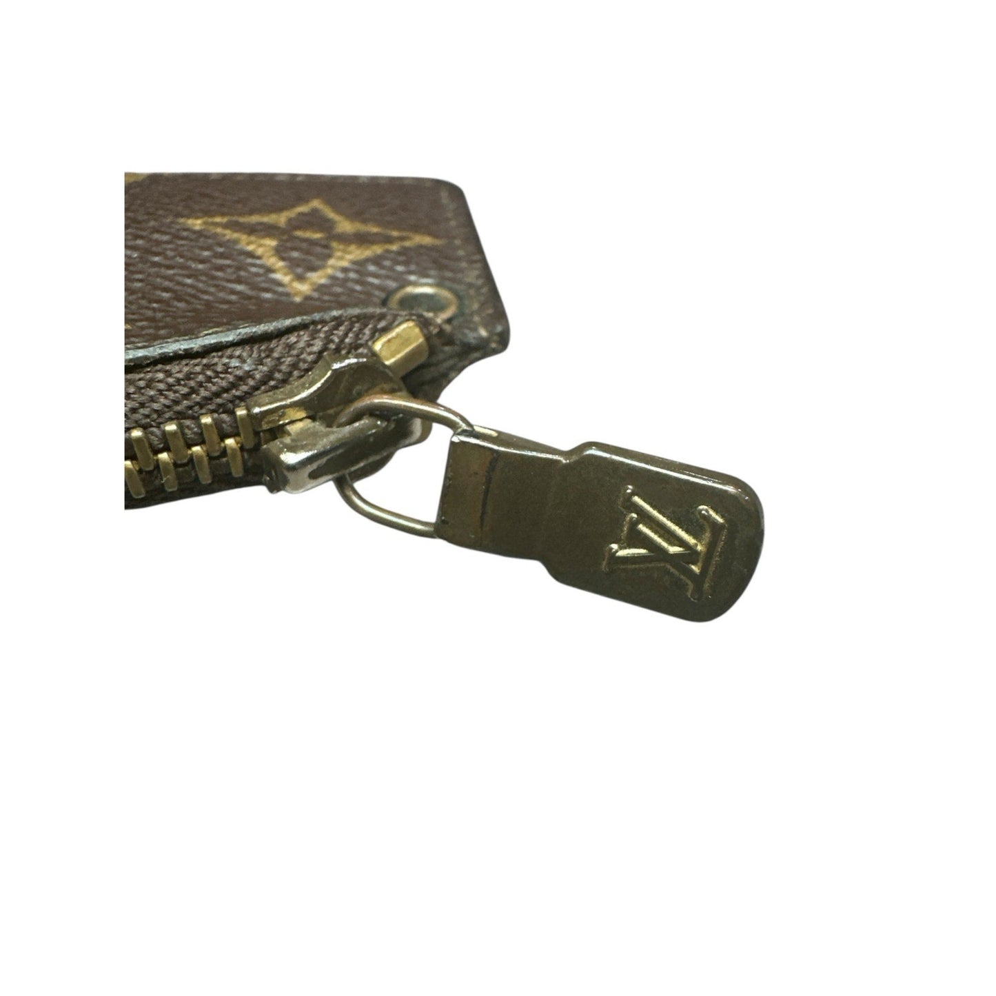 Close-up of a Louis Vuitton wallet zipper with logo on a white background