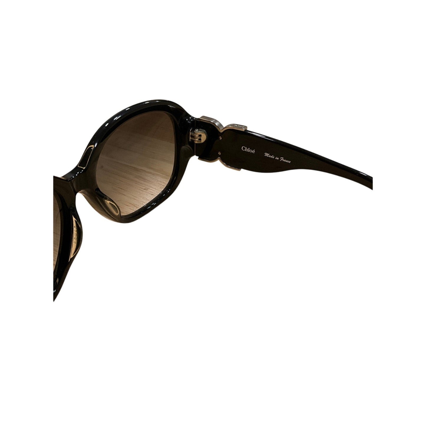 Black sunglasses with a reflective lens on a white background