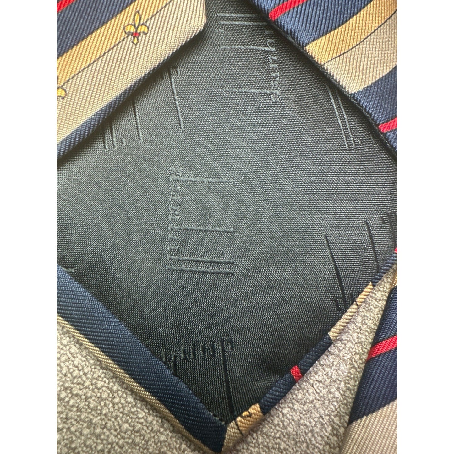 Close-up of a fabric texture with a brand logo on a striped background