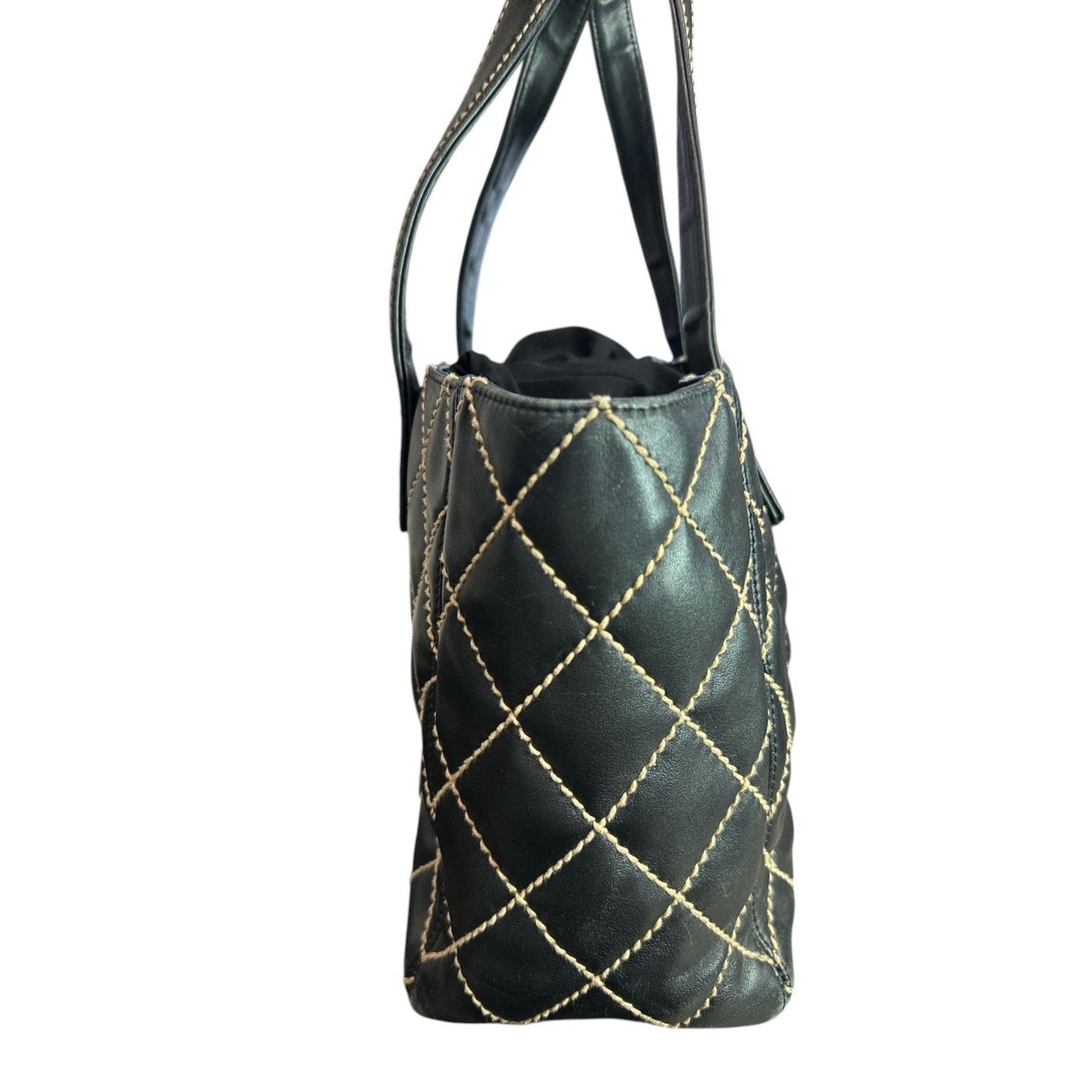 Black handbag with gold stitching on a white background