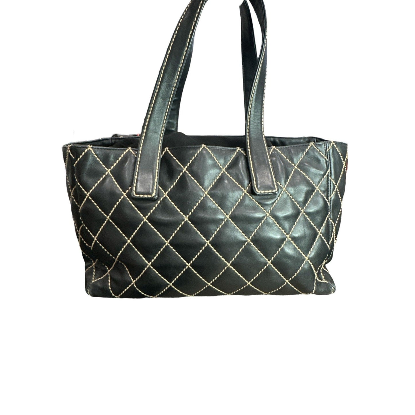 Black quilted handbag on a white background