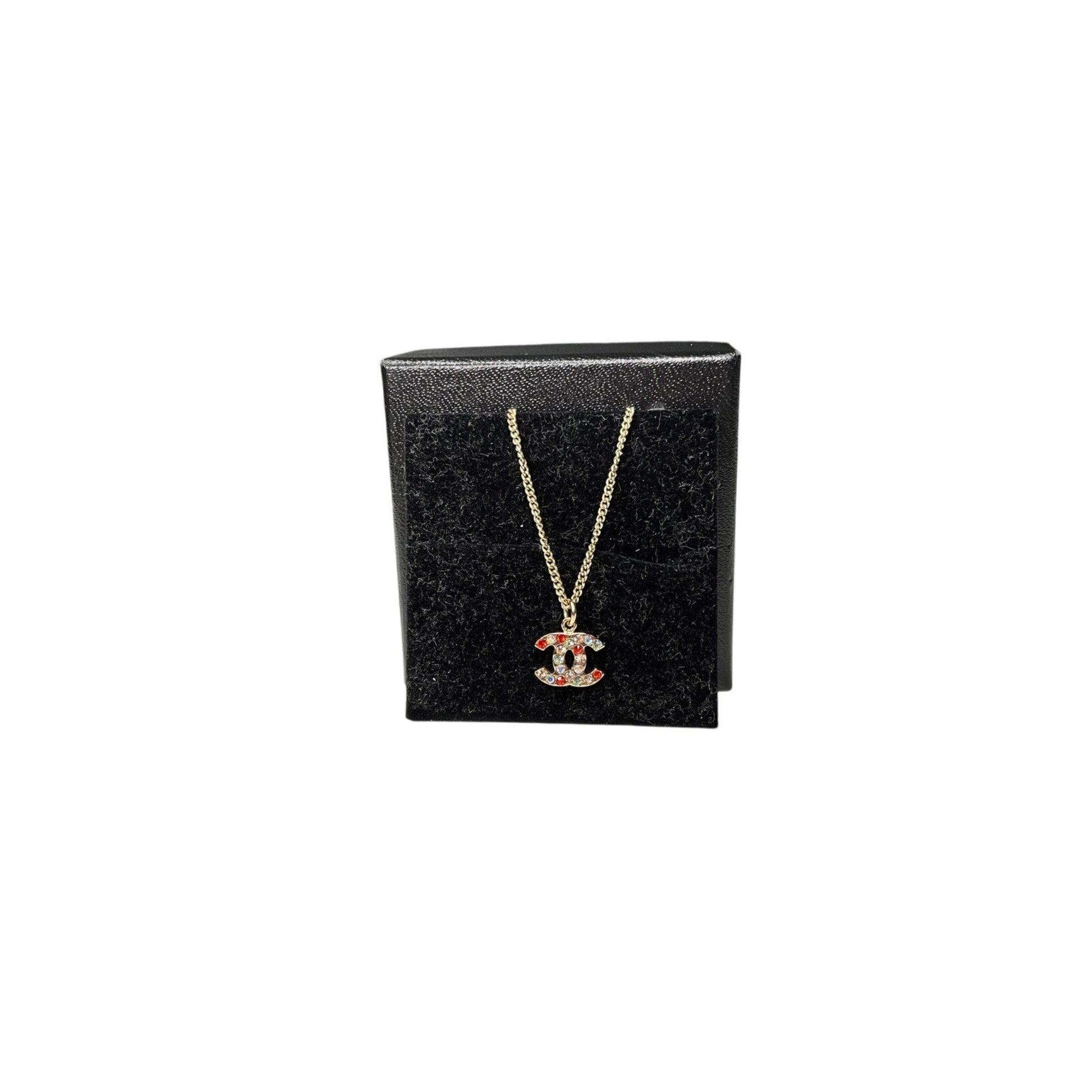 Chanel necklace on a black jewelry box with a white background