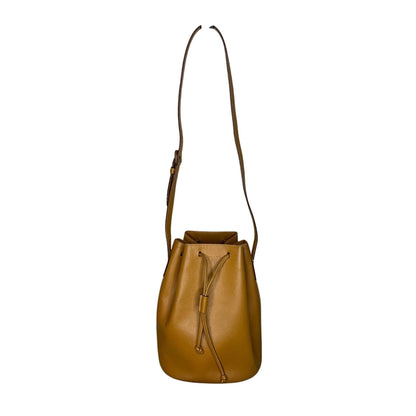 Brown leather bucket bag with a strap on a white background