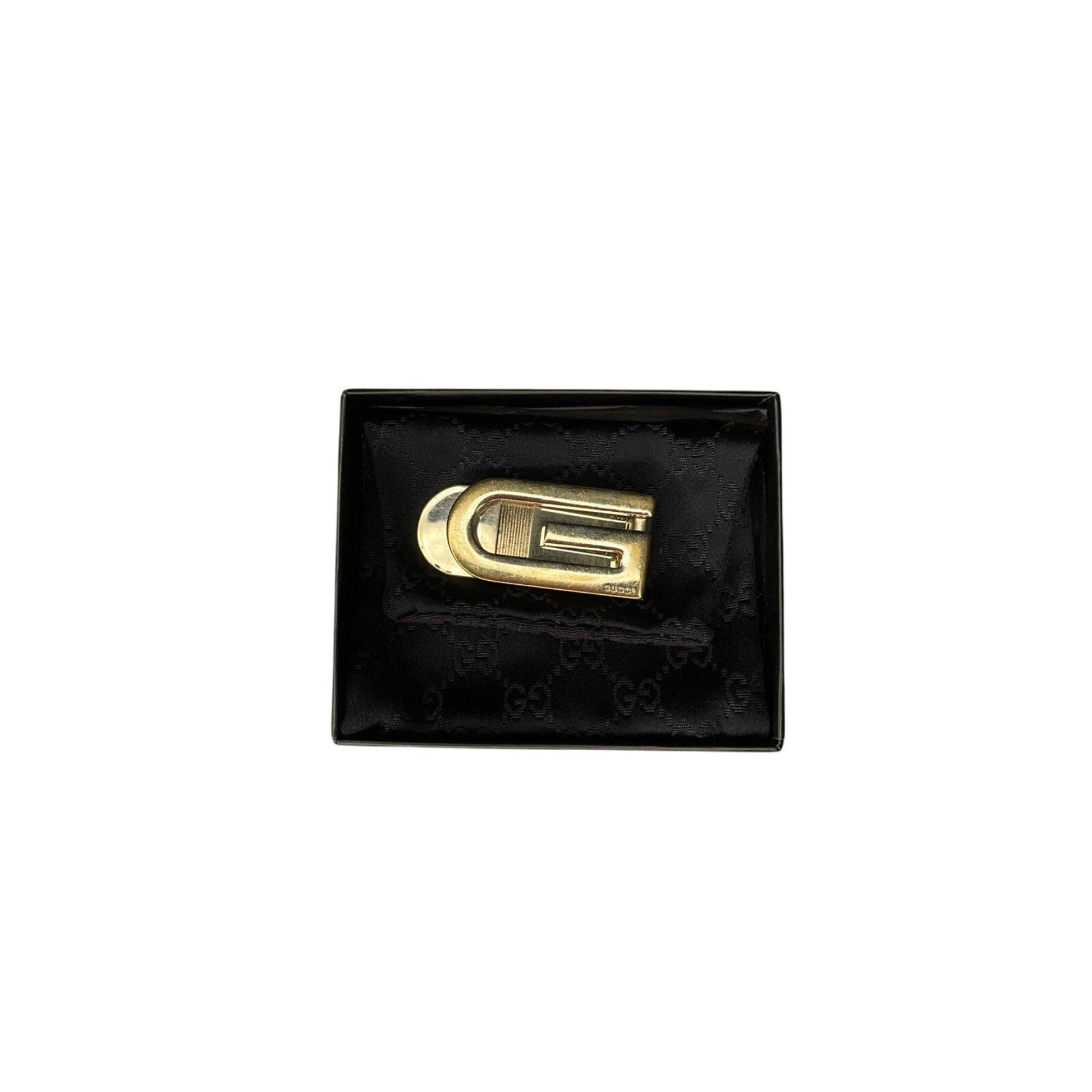 Gold logo on a black textured box
