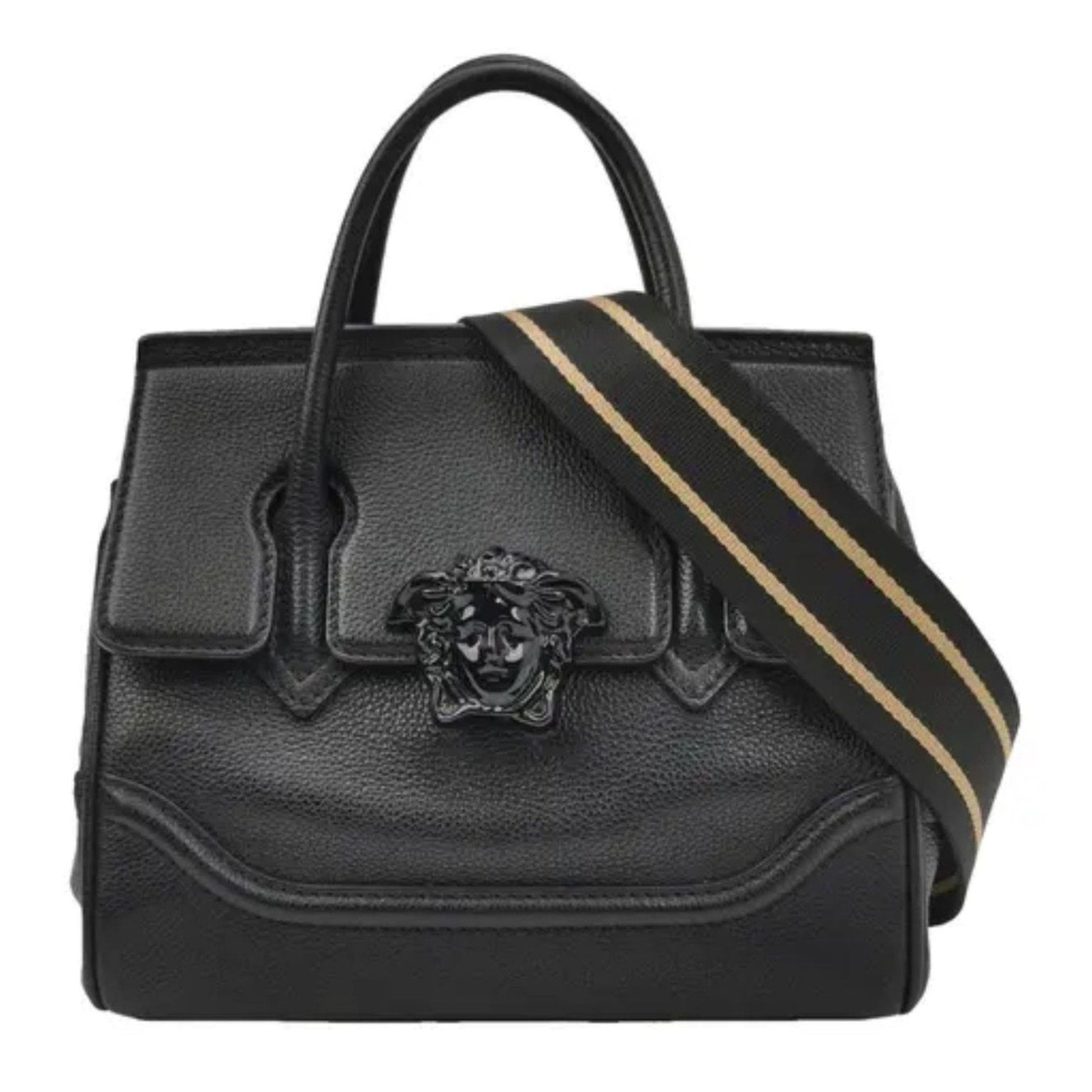 Black leather handbag with a gold stripe and emblem on a white background