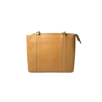 Tan leather clutch bag with gold zipper on a white background