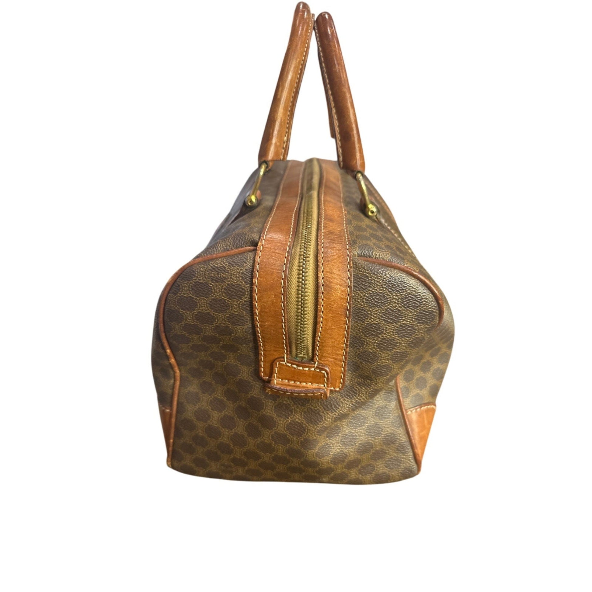 Brown patterned handbag with brown handles on a white background