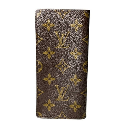 Brown wallet with gold monogram pattern on a white background