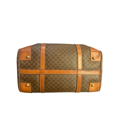 Brown patterned bag with gold accents on a white background