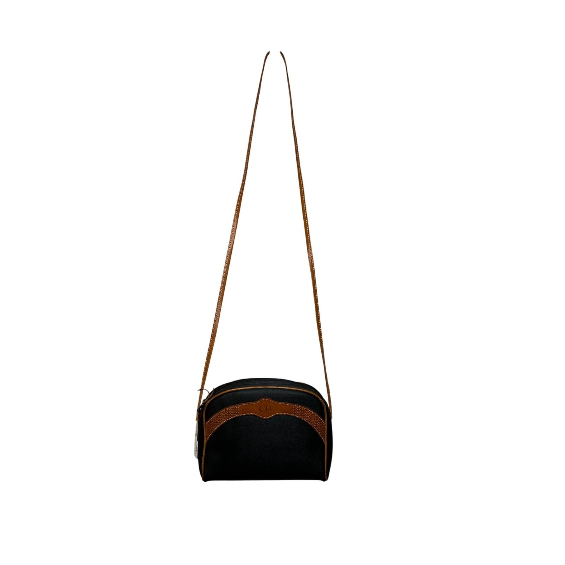 Black and brown bag with a strap on a white background