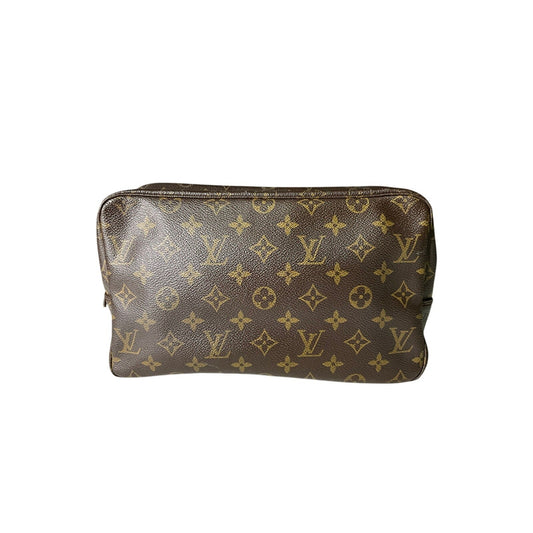 Brown leather pouch with gold monogram pattern on a white background