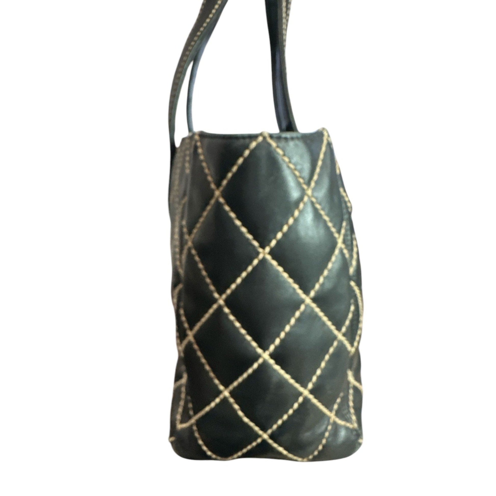 Black leather handbag with gold stitching on a white background