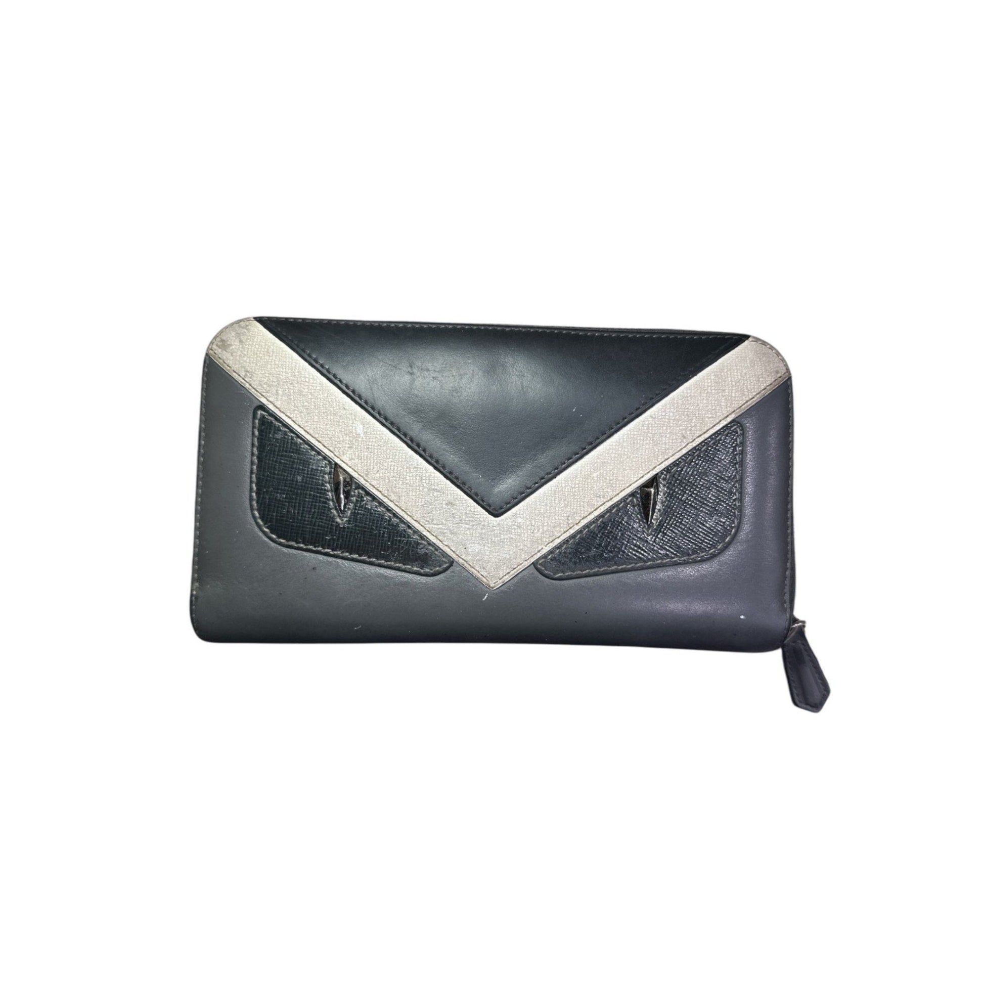 Black clutch bag with a white V-shaped design on a white background
