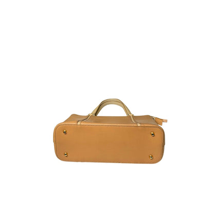 Tan leather handbag with gold accents on a white background
