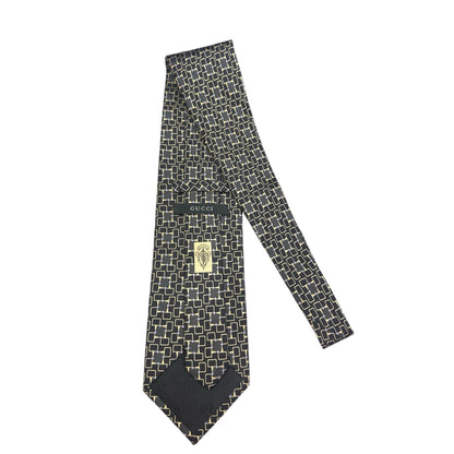 Black patterned tie with Gucci logo on a white background