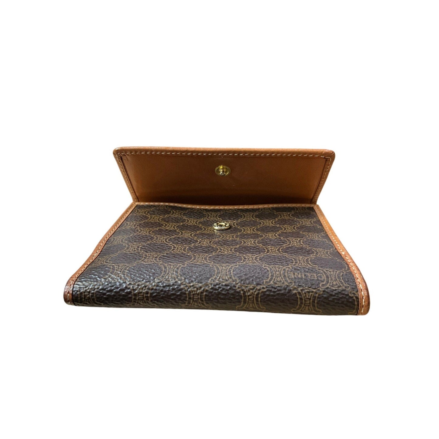 Brown leather wallet with patterned interior on a white background