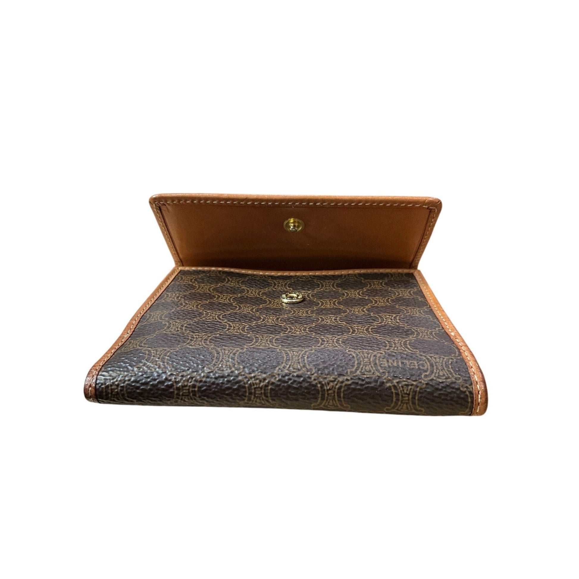 Brown leather wallet with patterned interior on a white background