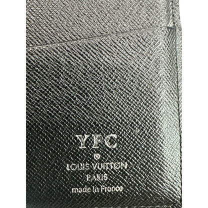 Close-up of a textured black leather product with 'YPC' and 'Louis Vuitton' branding.