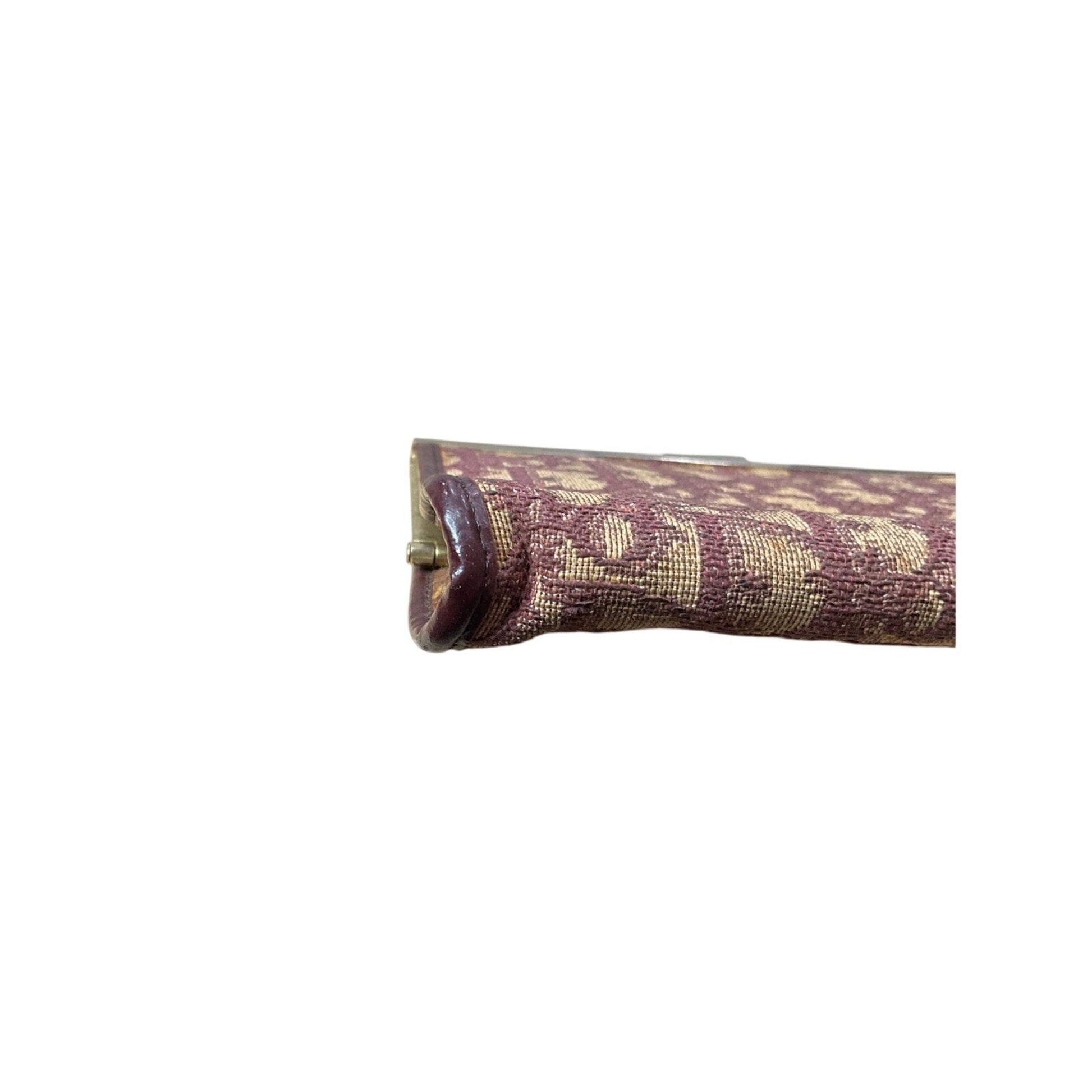 Roll of purple fabric with gold pattern on a white background