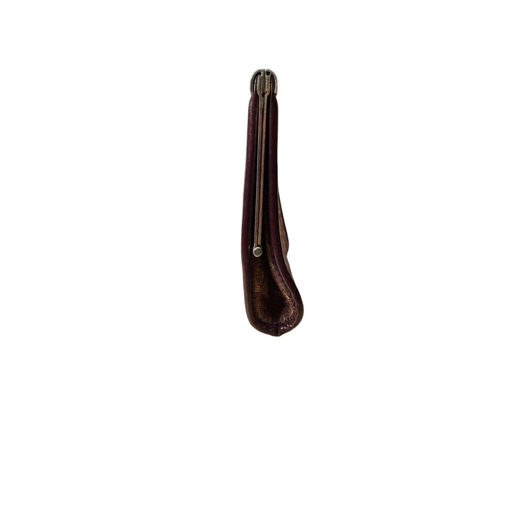 Brown leather case with a metal clip on a white background