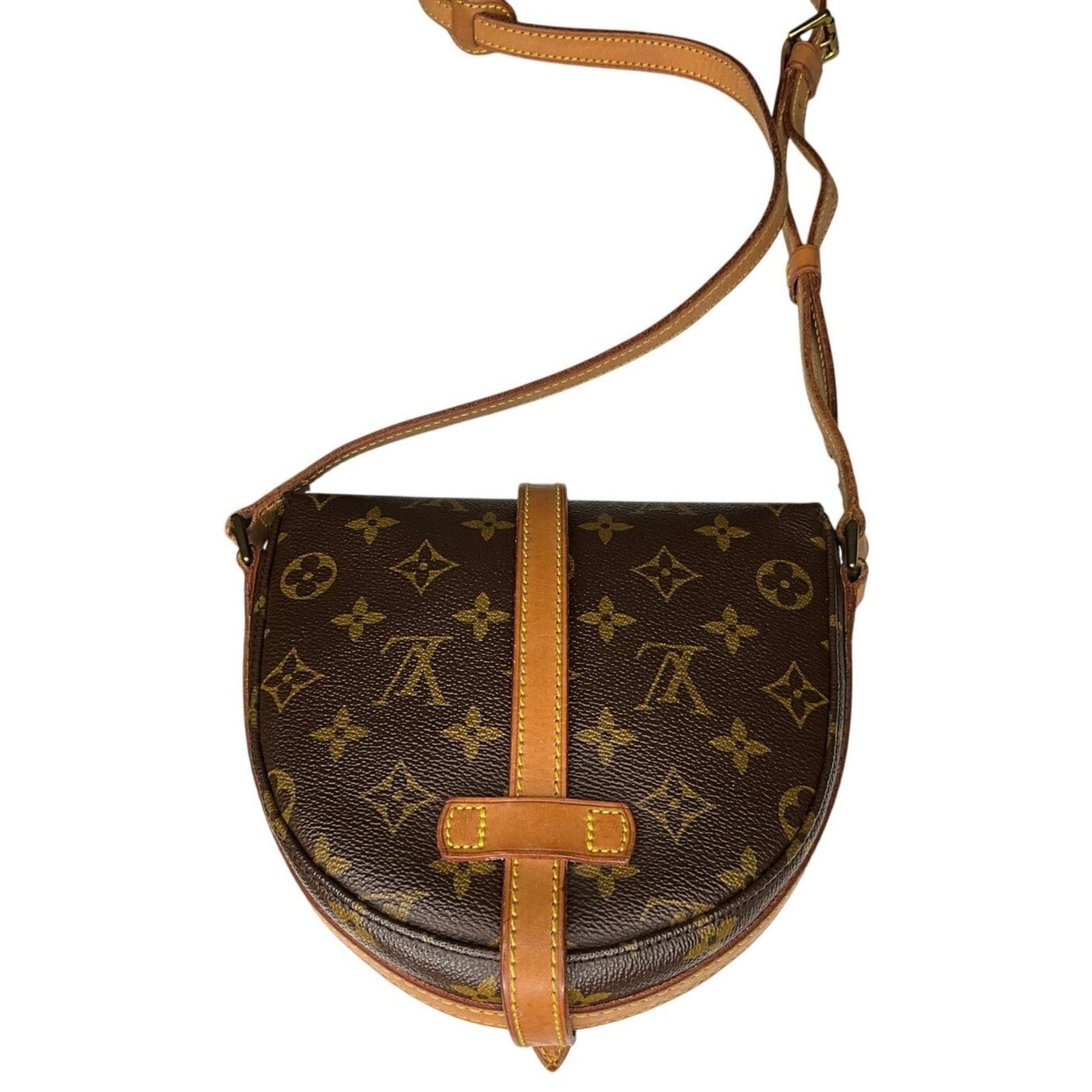 Brown monogram handbag with tan leather strap on a white background