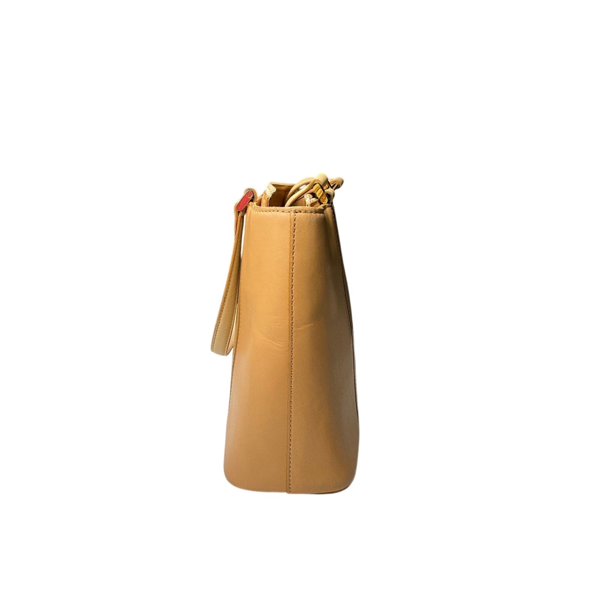 Tan leather bucket bag on a white background