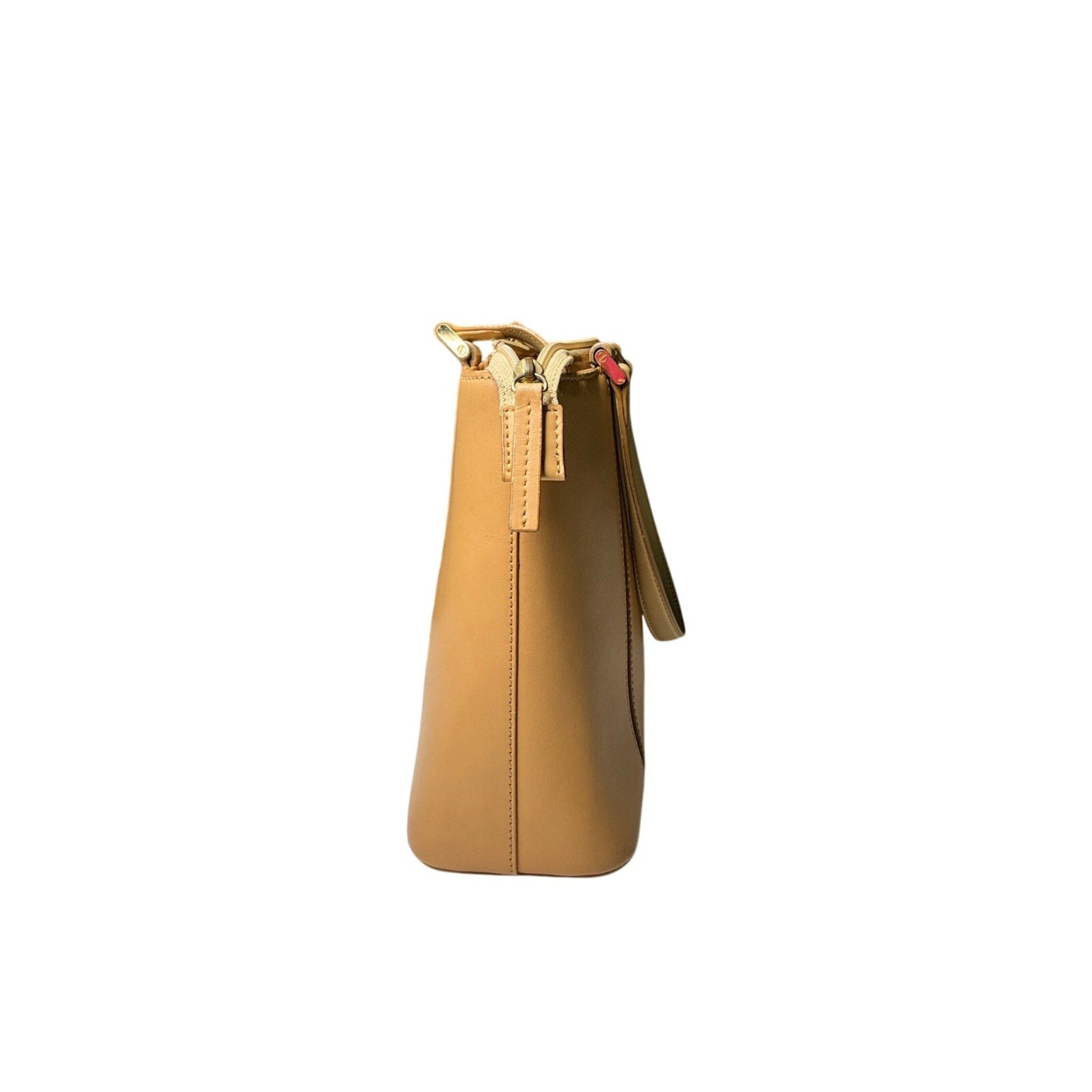 Tan handbag with gold accents on a white background