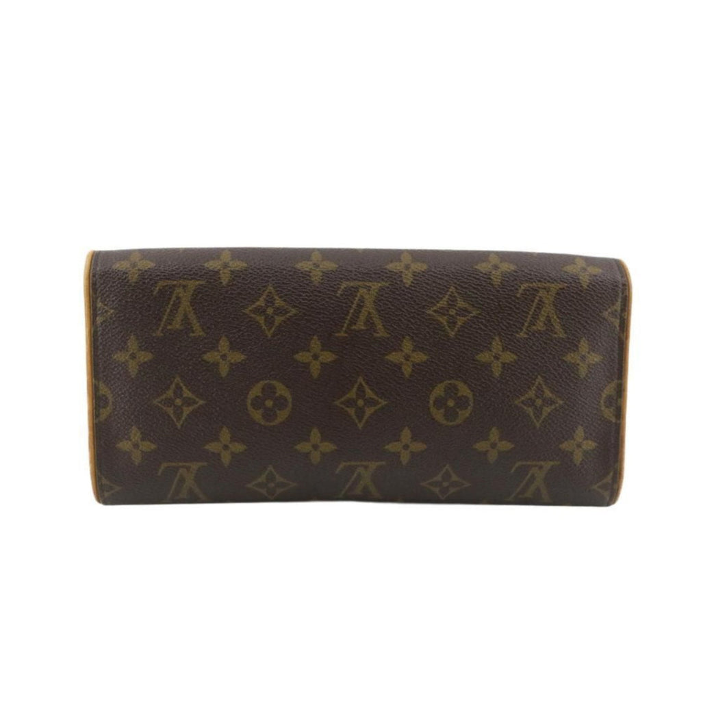 Brown wallet with gold monogram pattern on a white background