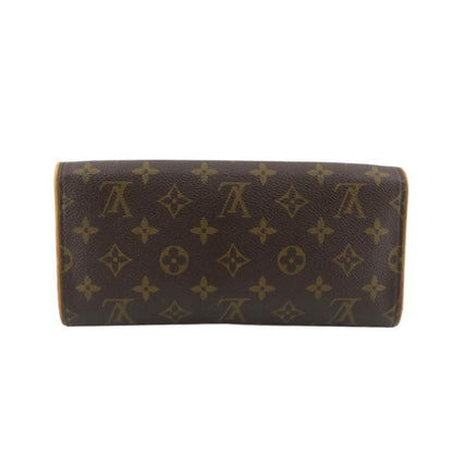 Brown wallet with gold monogram pattern on a white background