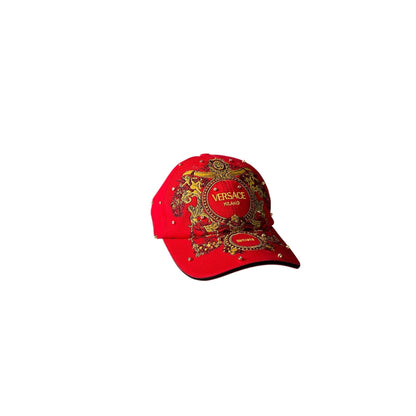 Red Versace cap with gold emblem on a white background
