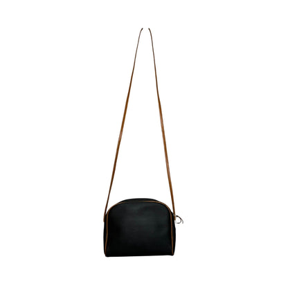 Black handbag with a brown strap on a white background