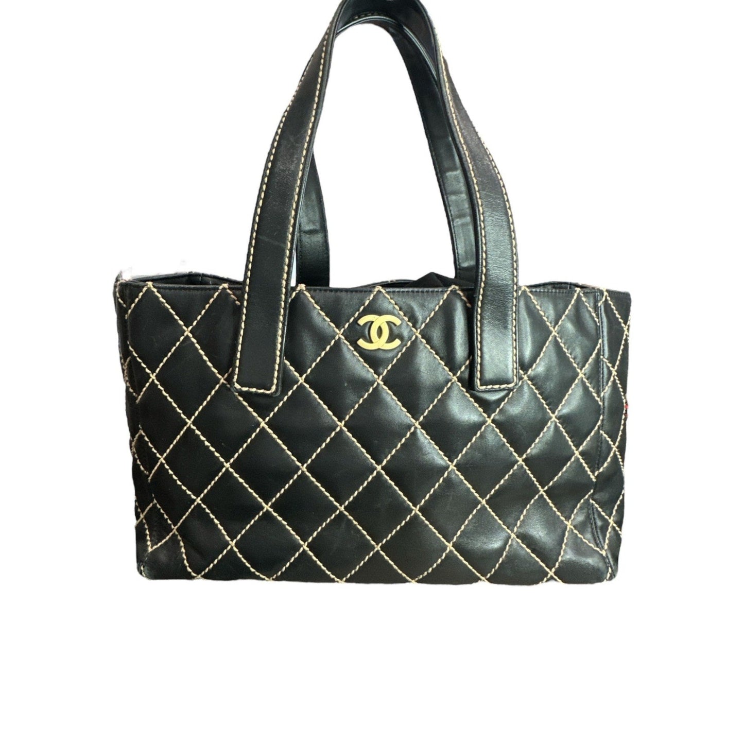 Black quilted handbag with gold stitching and Chanel logo on a white background