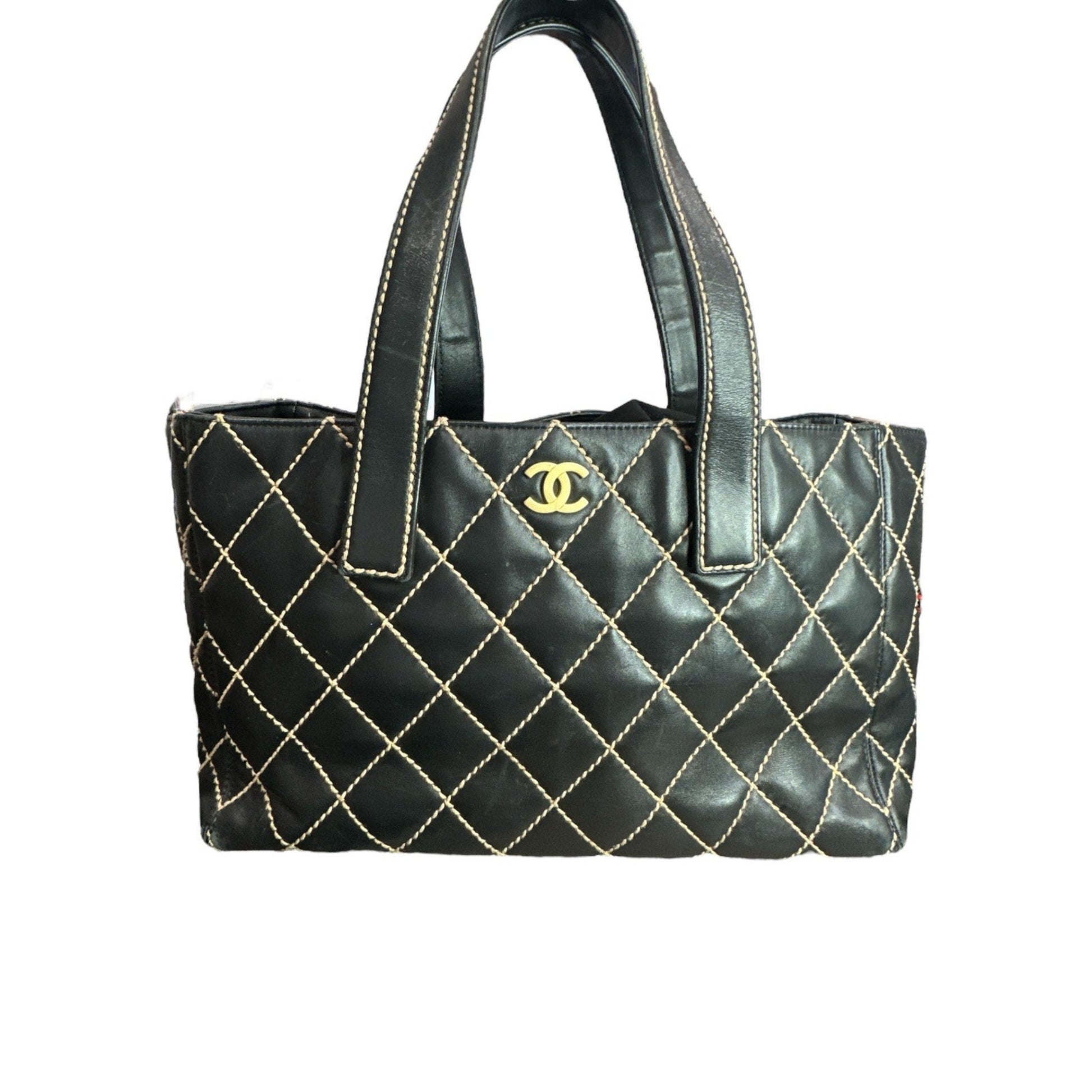Black quilted handbag with gold stitching and Chanel logo on a white background