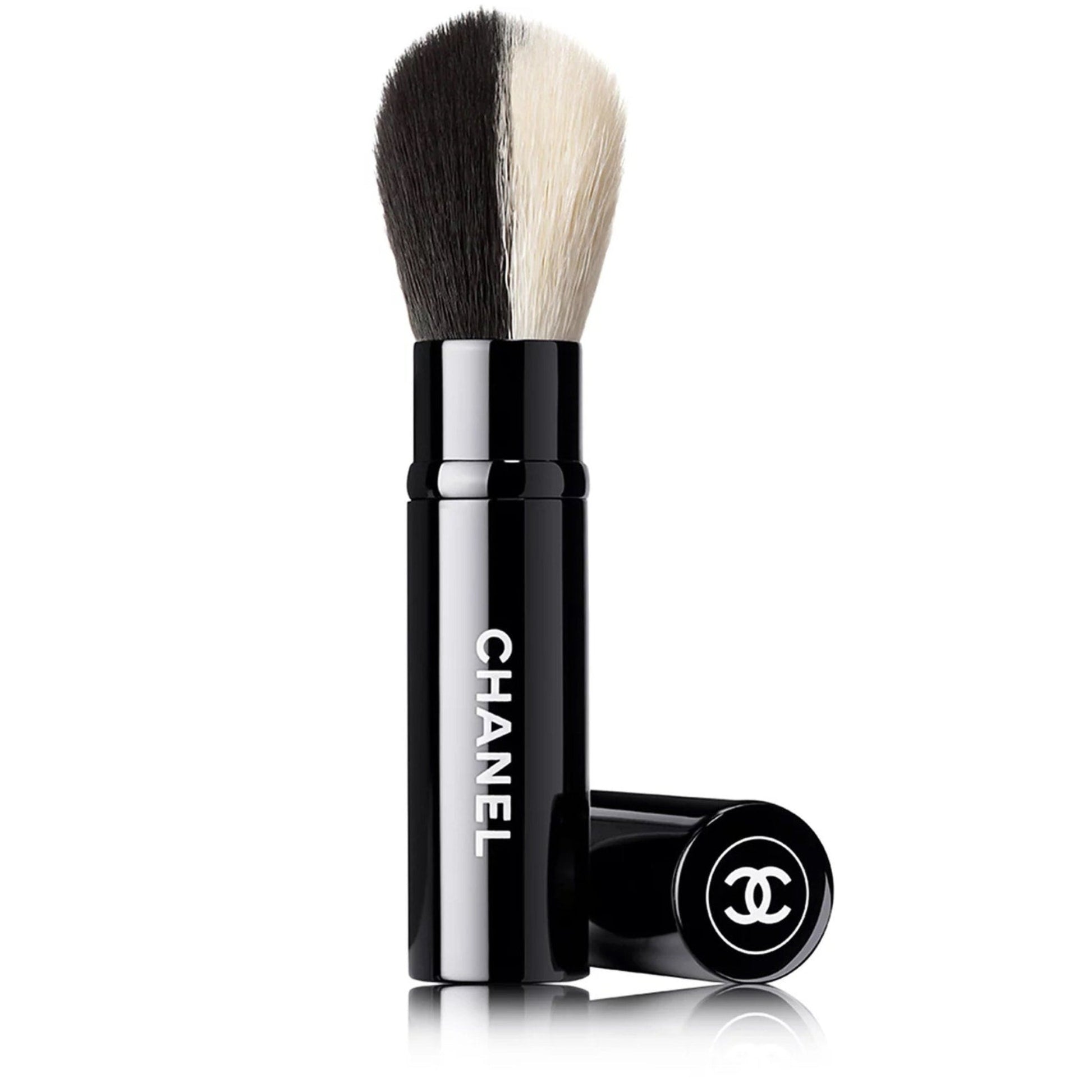 Chanel makeup brush with black and white bristles on a white background