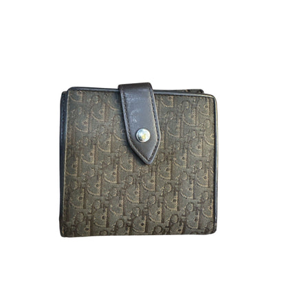 Patterned wallet with a leather strap on a white background