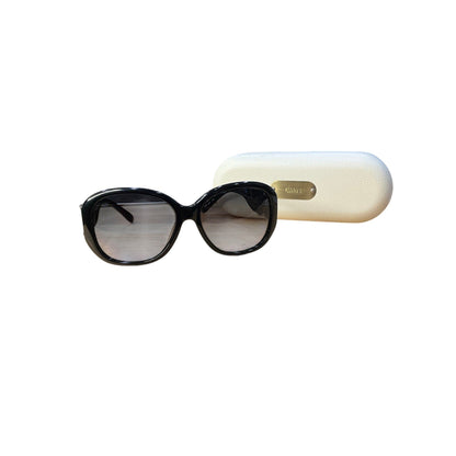 Black sunglasses with a beige case on a white background