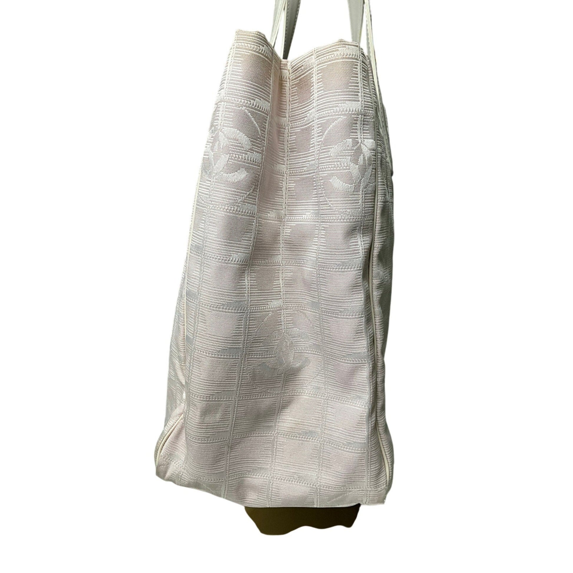 White tote bag with subtle pattern on a white background