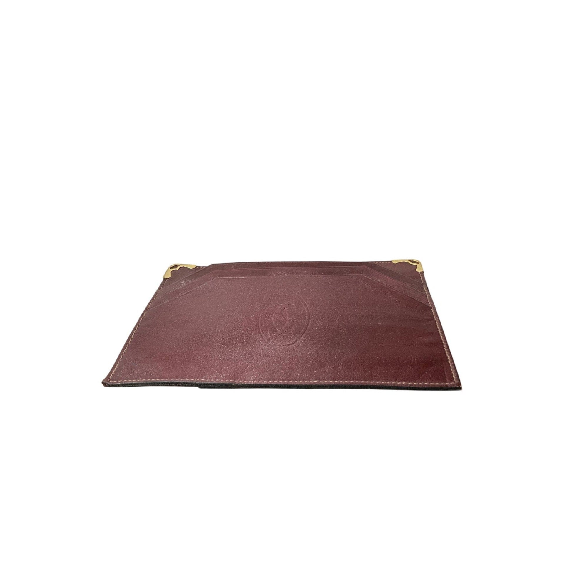 Brown leather pouch with gold zipper on a white background