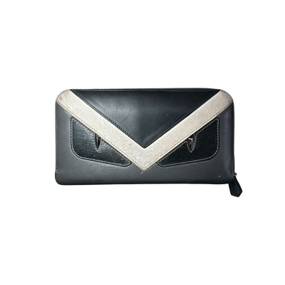 Black clutch bag with a white V-shaped design on a white background