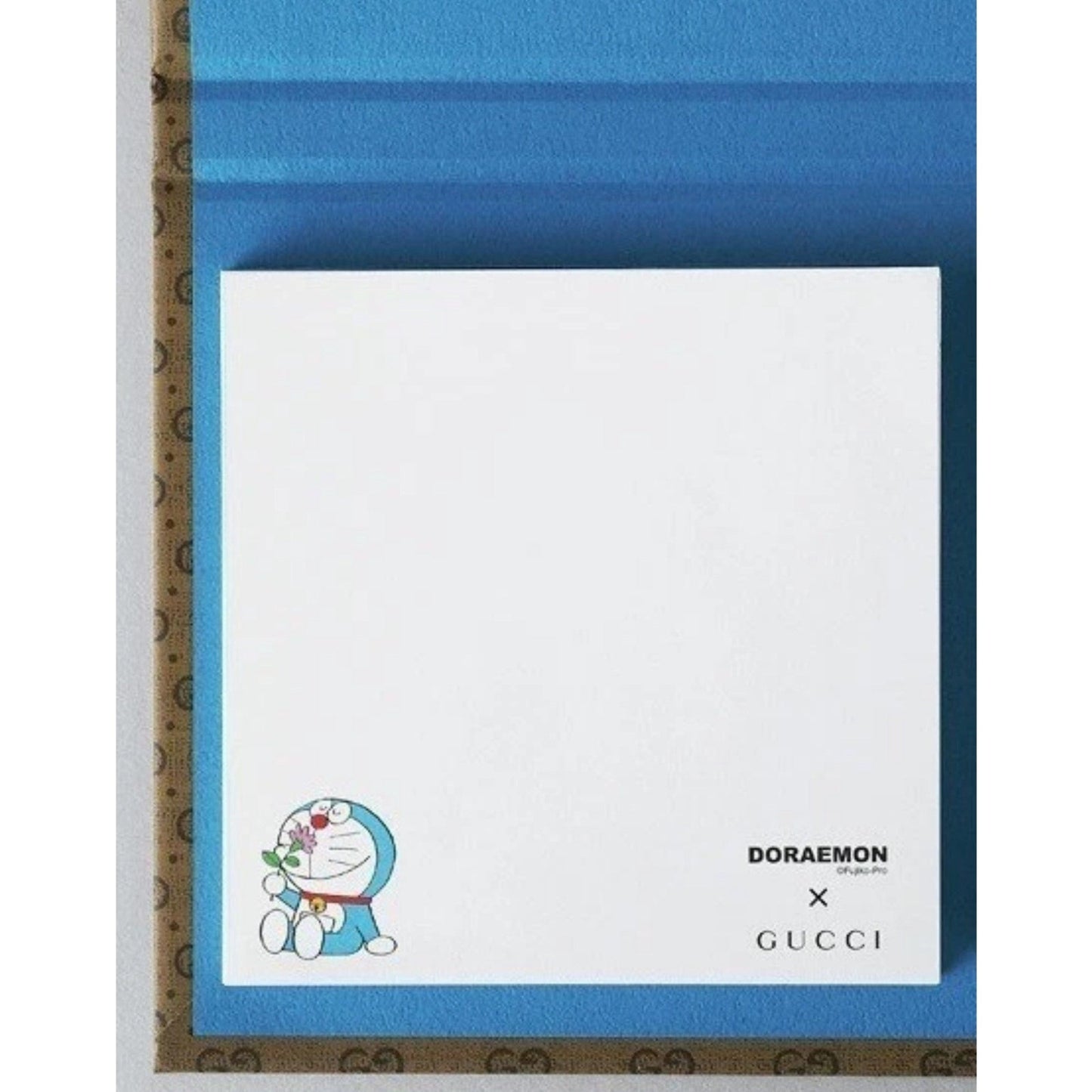 Gucci x Doraemon collaboration product with blue border and white center featuring Doraemon.