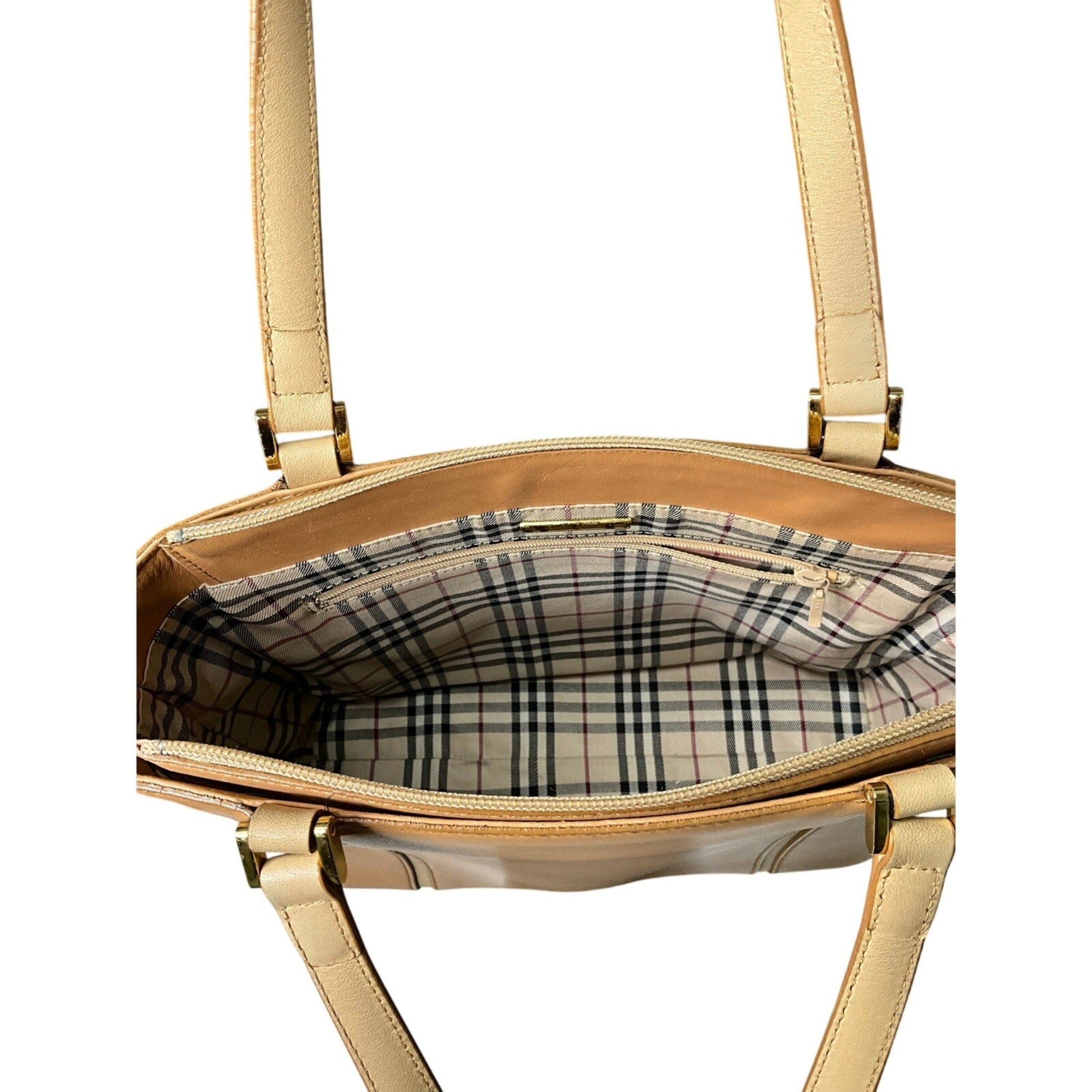 Beige handbag with plaid interior on a white background