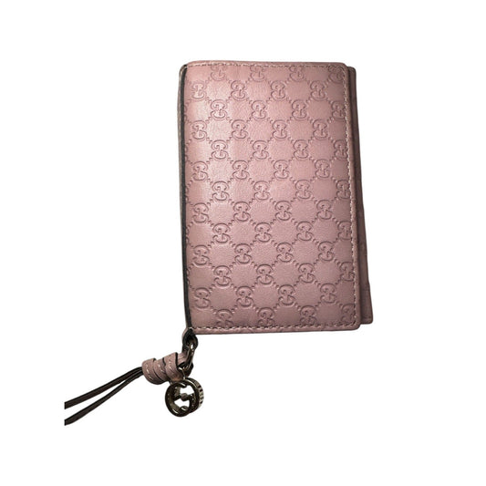 Pink wallet with brand logo on a white background