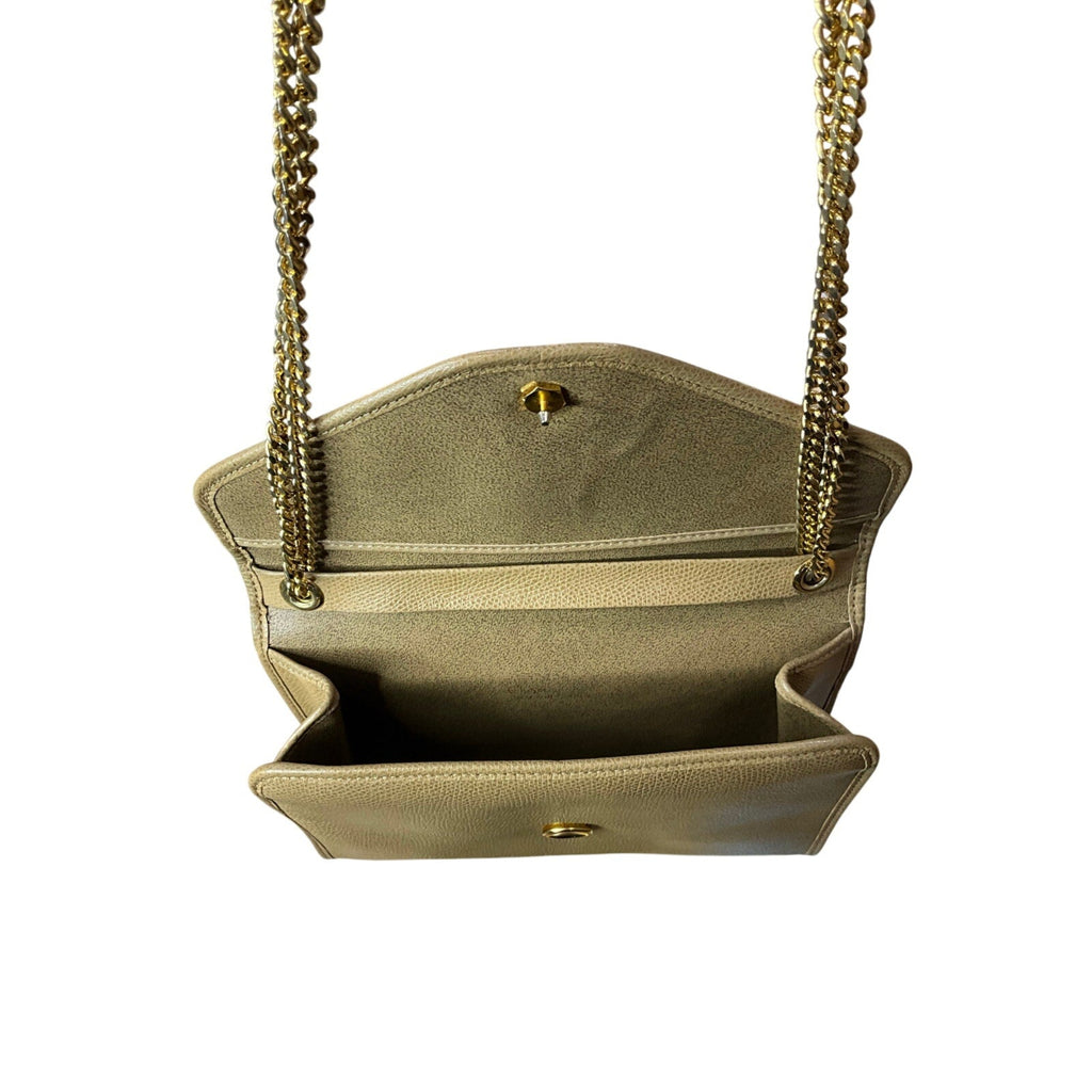 Beige handbag with gold chain strap on a white background