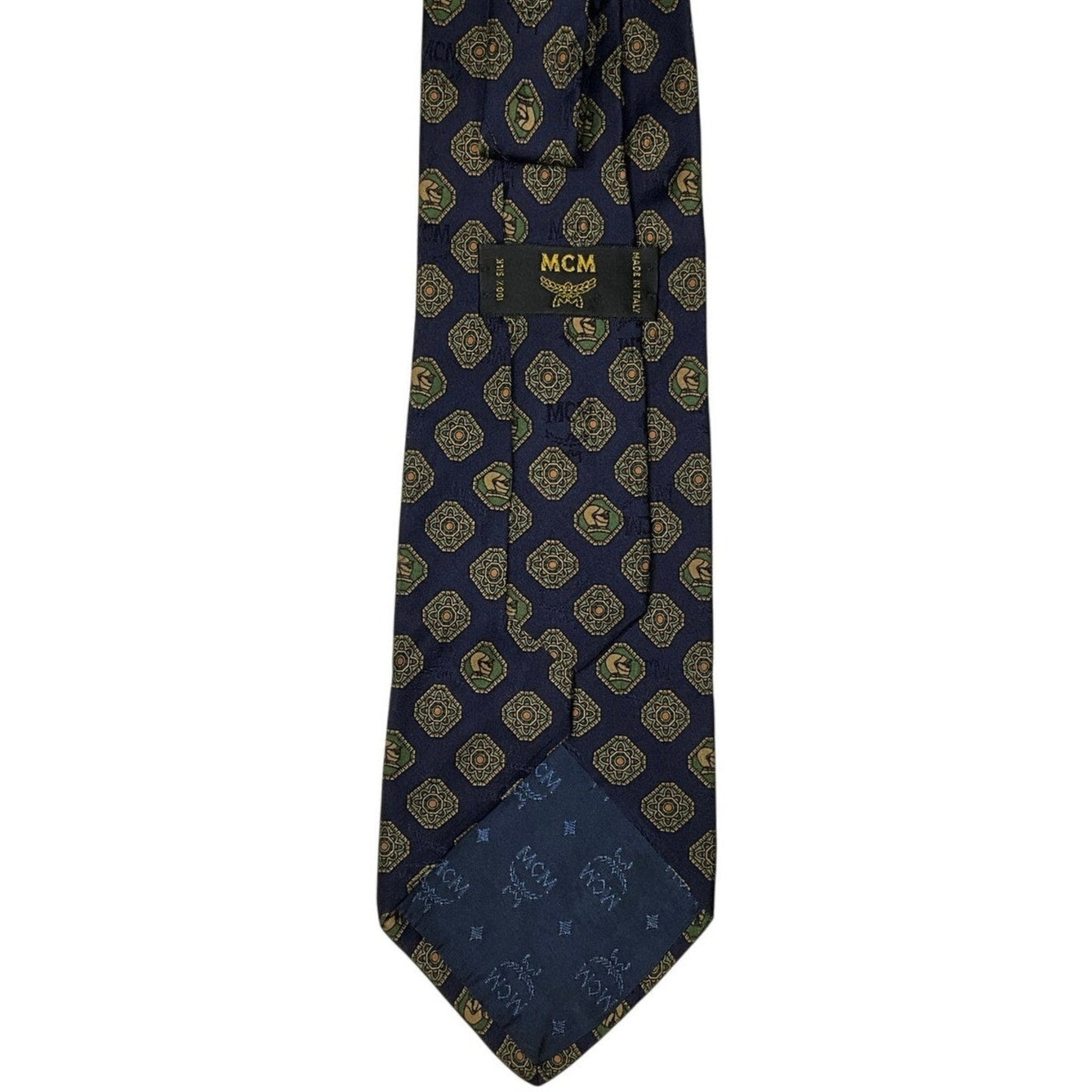 Navy blue tie with gold pattern and MCM logo on a white background
