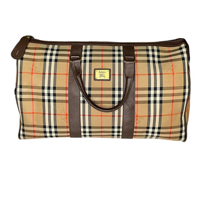 Plaid bag with brown handles on a white background