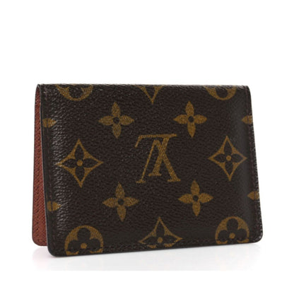 Brown wallet with gold monogram pattern on a white background