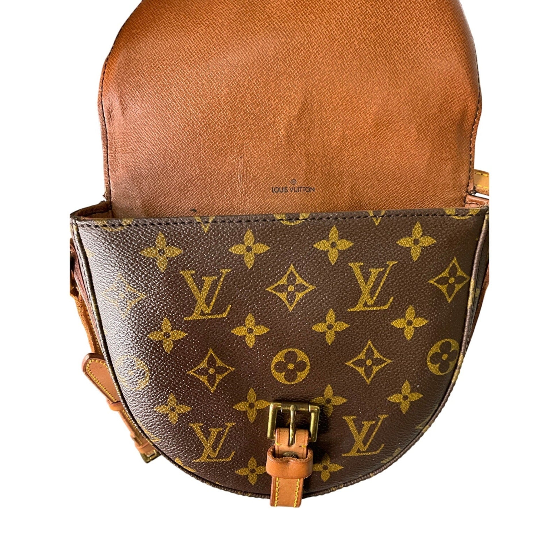 Brown leather handbag with gold monogram pattern on a white background