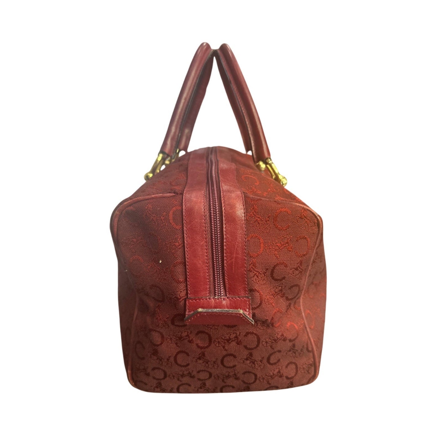 Brown handbag with gold accents on a white background